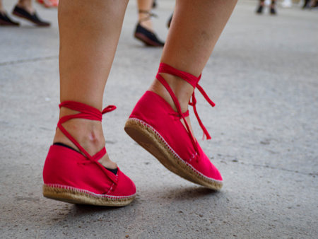 People dancing typical Catalan sardanas in a park during a traditional national holiday. Empty space for editor's text.の写真素材