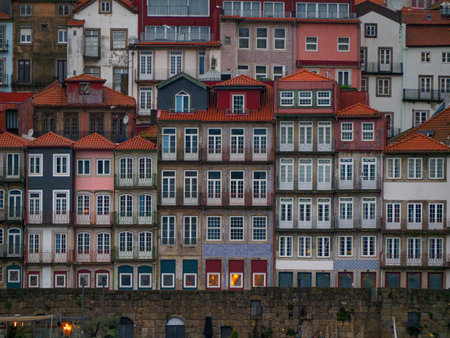 Close-up of the colorful typical tiled houses of the city of Porto in Portugal, with the Clerigos Tower in the background.の写真素材
