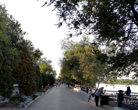 People walk along the embankment of the Baku lake.の写真素材