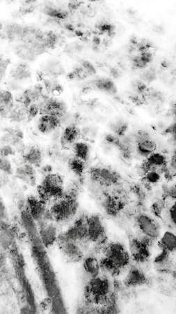 Background Footprints in the Snow Thawed Winterの写真素材