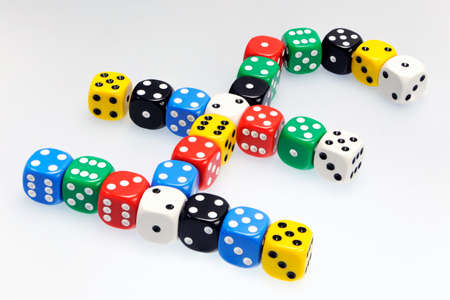 Dice in shape of a UK pound symbol illustrating risk in business and finance