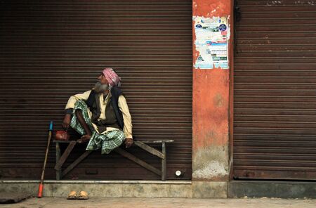 Old Indian Man Sitting on a Bench, Looking Sideways, Agra, Indiaのeditorial素材