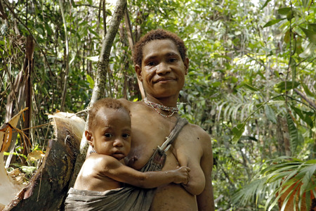 Mother and Child of the Nomadic Forest Tribe Korowai. West Papua, Indonesiaのeditorial素材