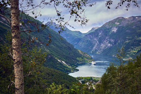 Aerial view of a Norwegian Fjord with an anchored ferry at the backgroundの写真素材
