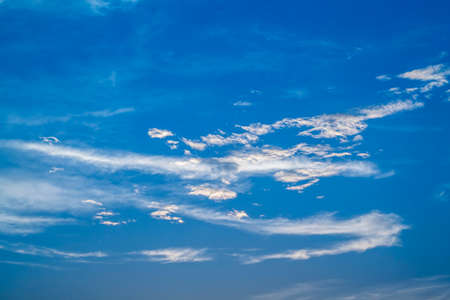 Soft white clouds against blue sky background