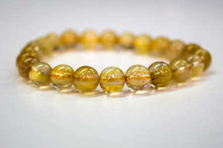 Golden Rutilated Quartz with a white backgroundの写真素材