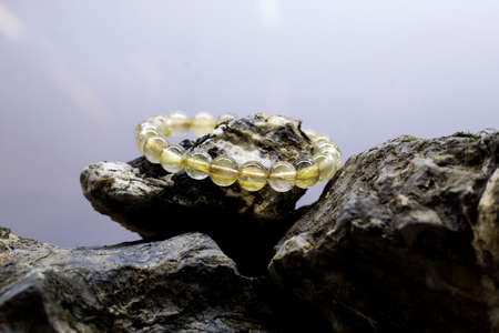 Golden Rutile Quartz , Golden rutilated quartz bracelet, Selective focus at the front of the bracelet and leaving the back of it blurry.の写真素材
