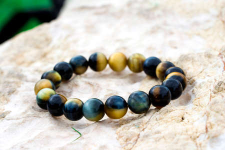 Tiger's eye (also called tiger eye) is a chatoyant gemstone that is usually a metamorphic rock with a golden to red-brown colour and a silky lustre.の写真素材