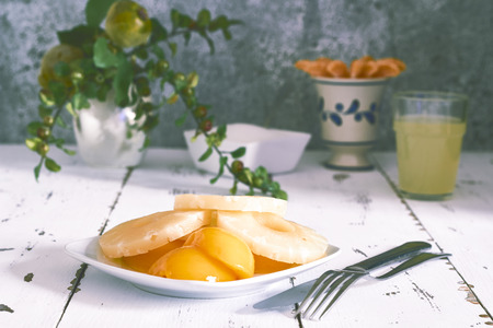 Pineapple and peach slices for a healthy vegetarian breakfastの写真素材