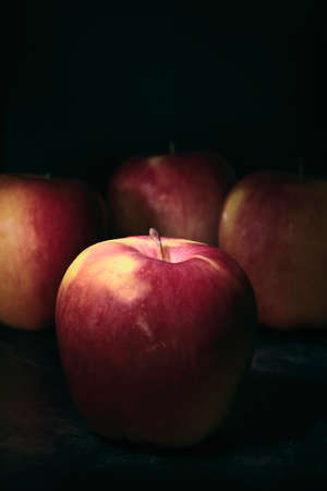 fresh and healthy fruit placed on a rustic table with very dark tonesの写真素材