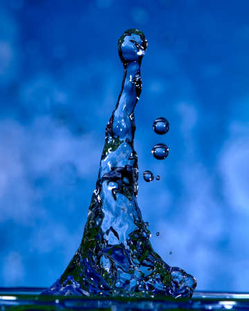 Drop falling on liquid generating a shape with texture and color