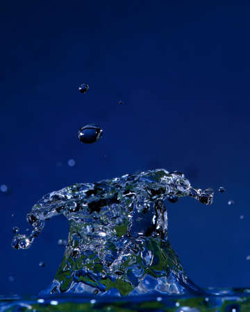 Drop falling on liquid generating a shape with texture and color