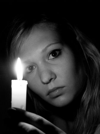 Girl with candleの写真素材