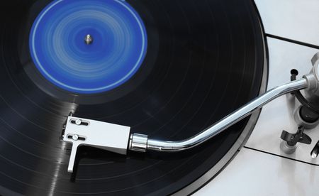 Closeup shot of spinning vinyl over a gray turntable