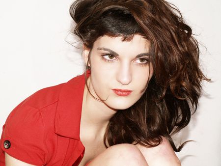 Young woman in red dress posingの写真素材