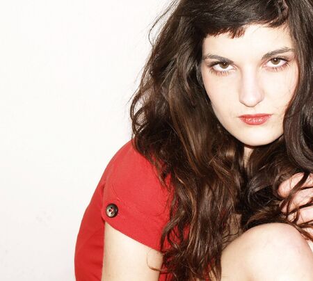 Young woman in red dress posingの写真素材