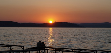 Romantic scene with a couple at a lakeの写真素材