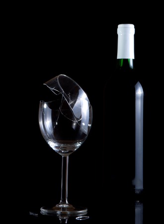 Vine bottle and broken glass on dark backgroundの写真素材