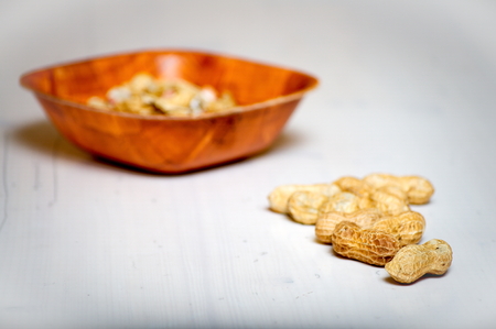 Peanuts in a brown bowlの写真素材