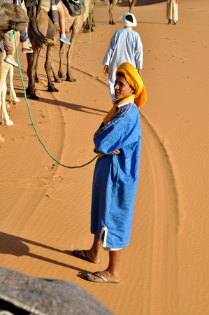 MERZOUGA DESERT - OCTOBER 01  Man in traditional Berber wear, walking in Merzouga Desert, Morocco on October 01, 2013 のeditorial素材