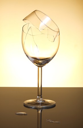 Broken vine glass on orange backgroundの写真素材