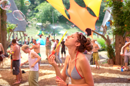 OZORA, HUNGARY - AUGUST 01  Girl blowing bubles on Ozora Festival, one of the greatest psychedelic music gathering in Euorpe  Ozora, Hungary, Europe August 01, 2014 のeditorial素材
