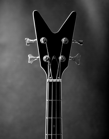 Neck of a black bass guitarの写真素材