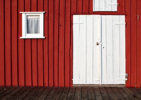 White door on red wallの写真素材