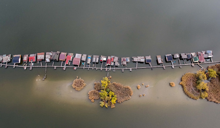 Aerial view of fishing buildings on a lakeの写真素材
