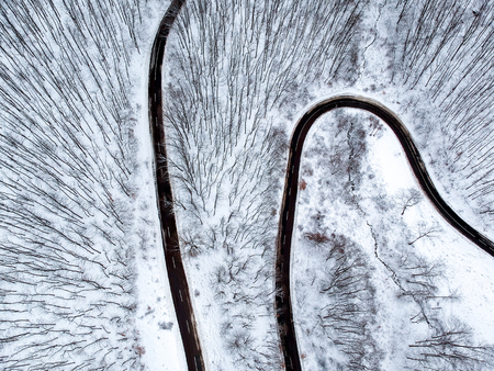Aerial view of winding road in winterの写真素材