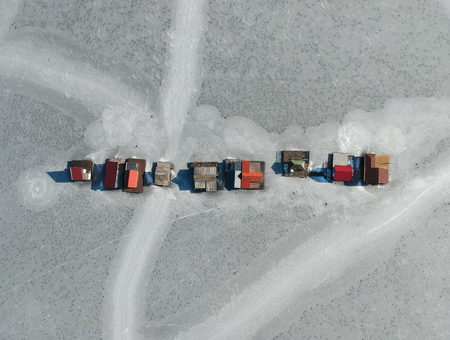 Fishing houses on a frozen lake at Bokod, Hungaryの写真素材