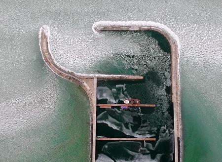Boats frozen in the water on lake Balaton, Hungaryの写真素材