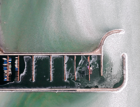 Boats frozen in the water on lake Balaton, Hungary