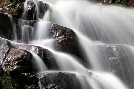 Small waterfall in the forest at autumnの写真素材