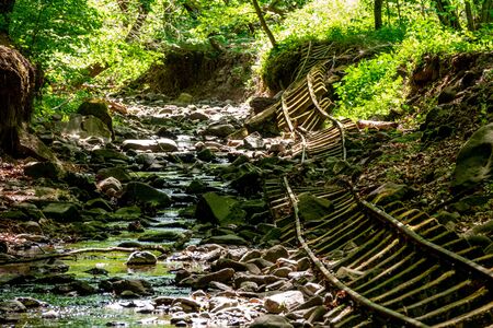 Old abandoned mining train rails in the dark forest