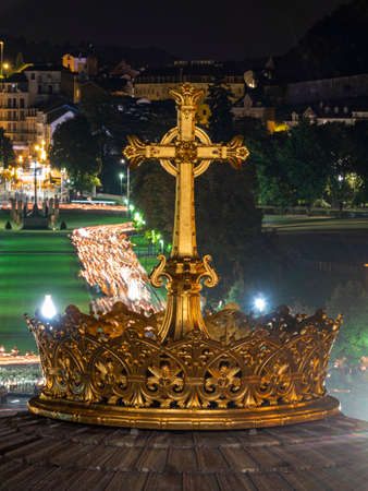LOURDES, FRANCE - SEPTEMBER 14 2019: Cross in front of the candle procession, every night in Lourdes, France, Europeのeditorial素材