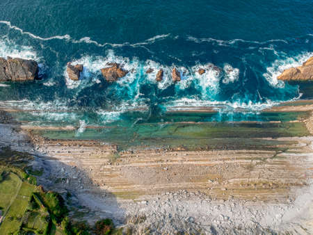 Dramatic view of Playa de la Arnia, rocky coastline in Santander ,Cantabria, Spainの写真素材