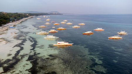 Aerial view of the beach with fishing boats in Bohol, Philippinesの写真素材