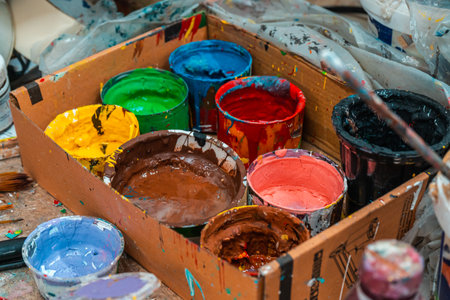 Jars with bright colors of the artist in the art workshop