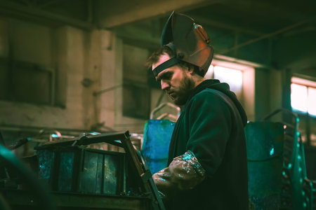 21.10.2021, Almaty, Almaty region, Kazakhstan. The welder works with metal at the factoryのeditorial素材