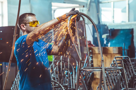08/06/2021, Almaty, Almaty region, Kazakhstan. An employee at the factory processes metal, sparks...