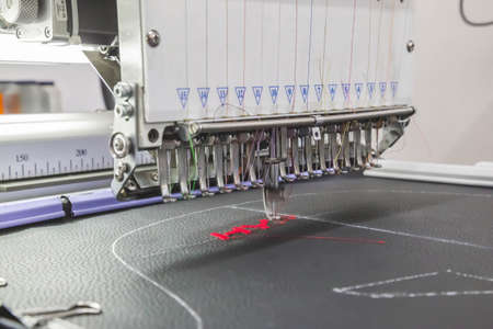 The embroidery machine embroider threads on fabric in the workshop