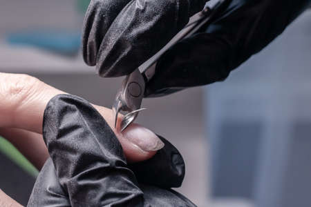 The process of manicure in a beauty salon close-up. cuticle removalの写真素材