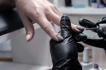 The process of manicure in a beauty salon close-upの写真素材