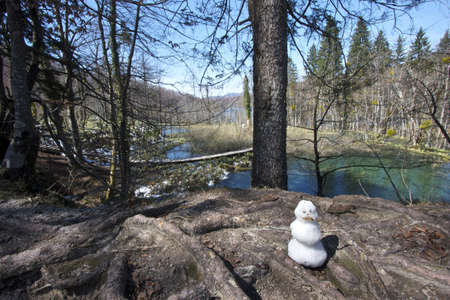 A lonely snowman melting away in spring before next winter arrives  Plitvice Lakes, Croatiaの写真素材