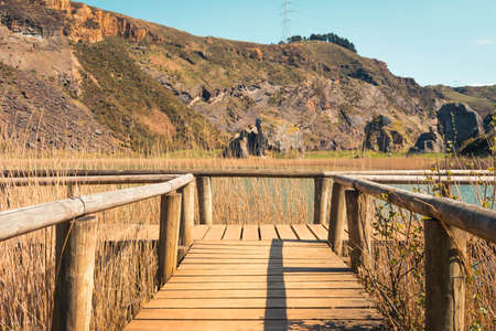 wooden footbridge on a lake during spring, la arboleda, basque countryの写真素材