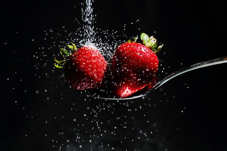 Sugar falling on Strawberriesの写真素材