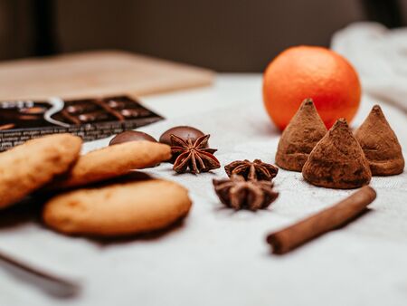 Truffles anise chocolate and cookies on linen backgroundの写真素材