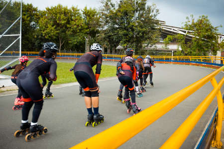 group of teenage boys skating on skating rink on cloudy day