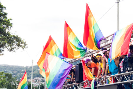 truck with lgbt flags in prime and lgbt people in festival happy for their rights outdoors